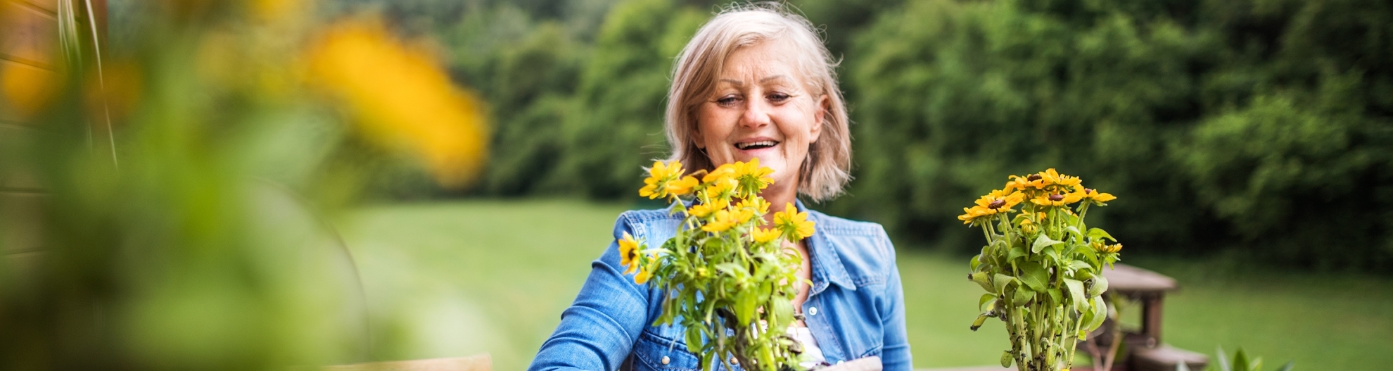 Senior woman potting flowers